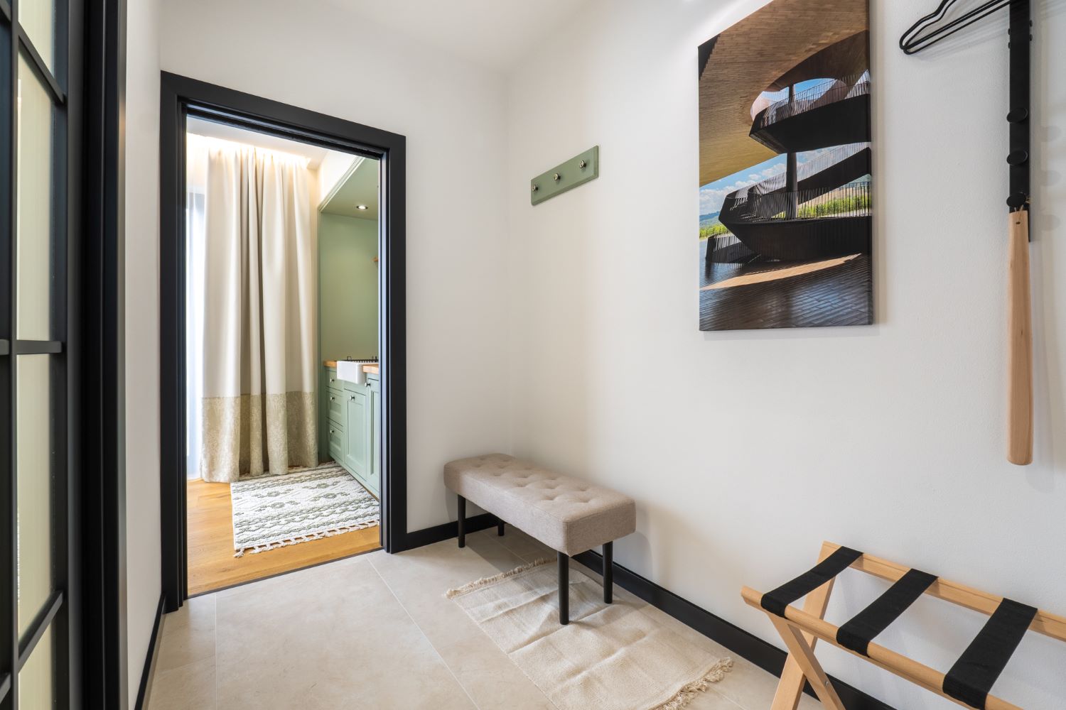 Vstupní chodba apartmánu Itálie s lavicí, stojanem na zavazadla a obrazem na zdi